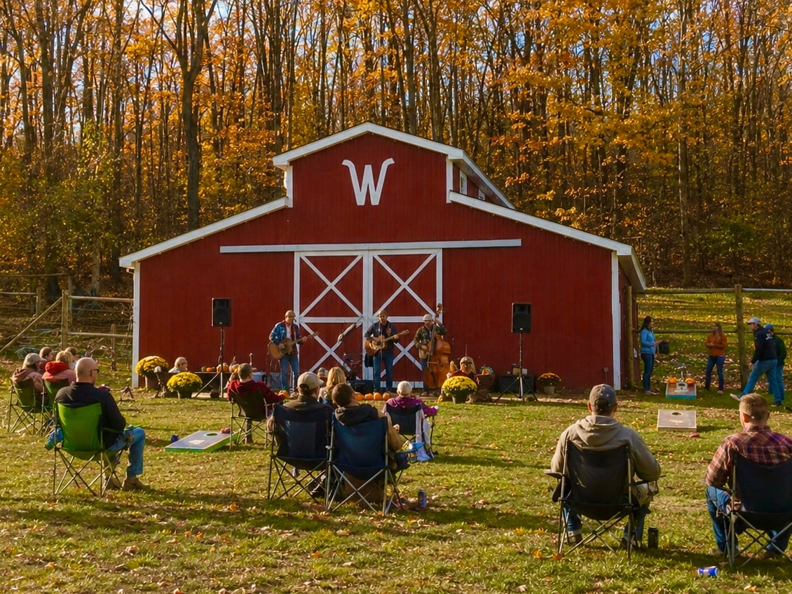 A full band playing outside the red barn at Wilderness Valley Farm in Gaylord, Michigan